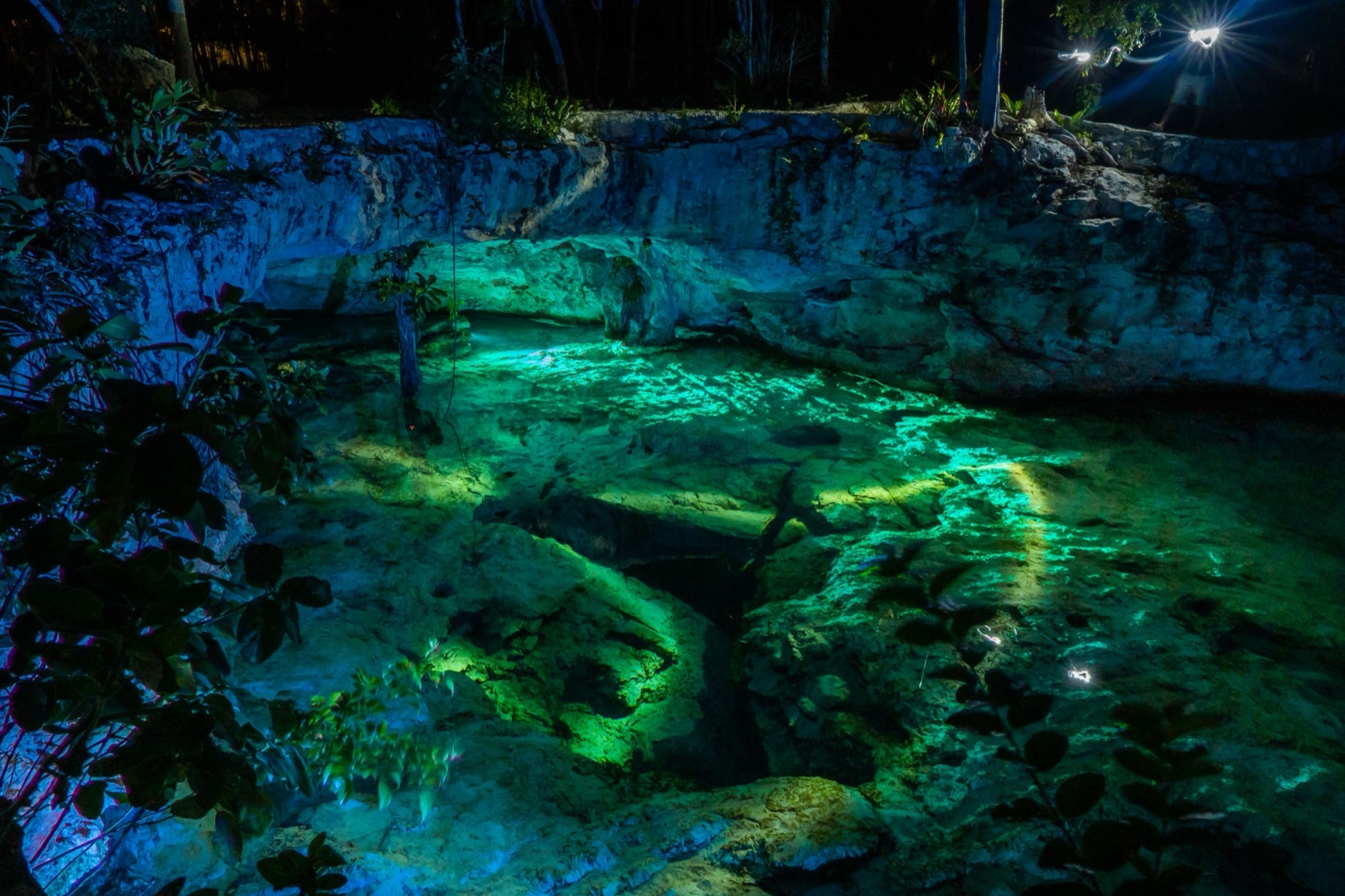 A cenote lit up at night
